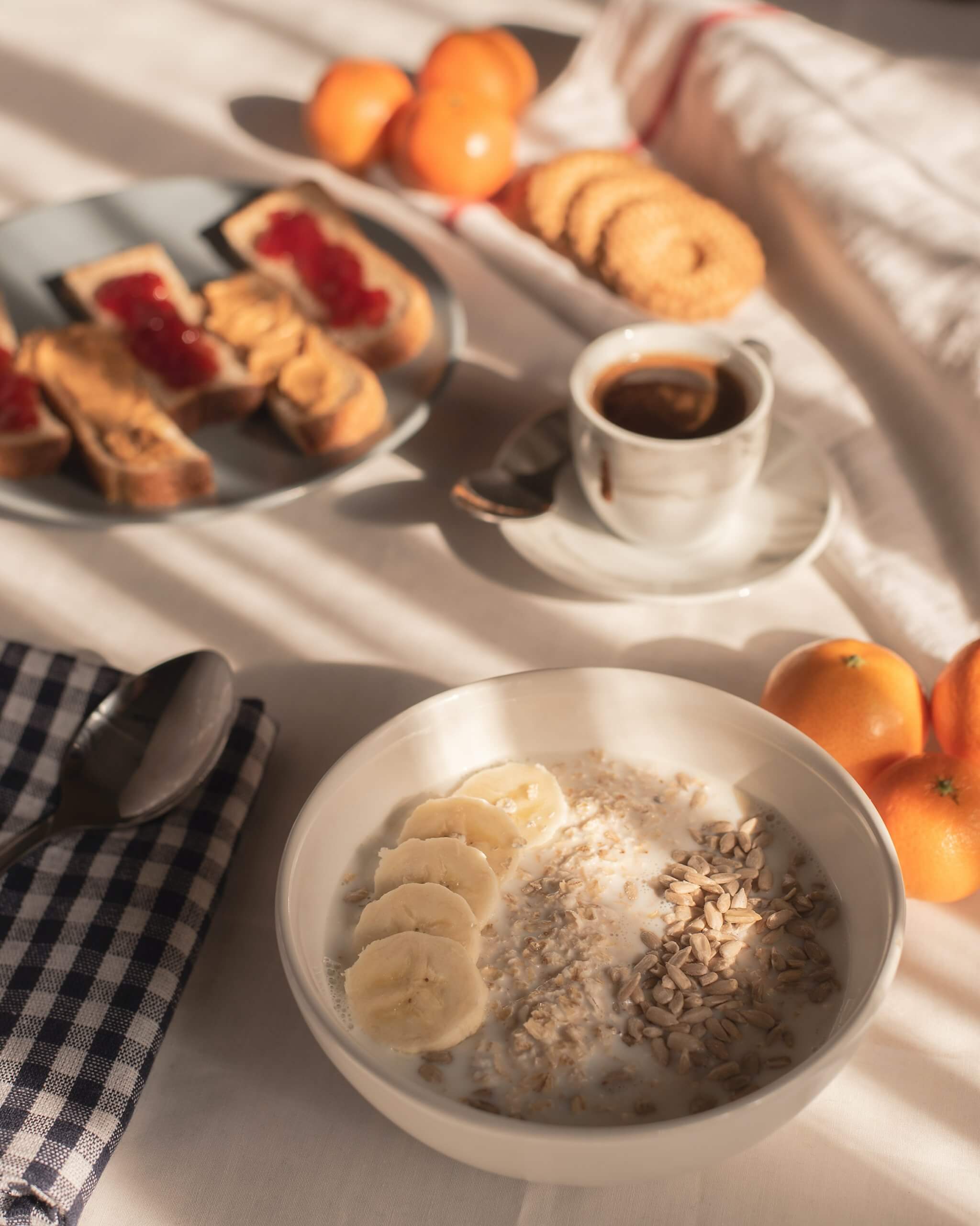 A table with oatmeal, pastries, and coffee for breakfast.